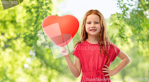 Image of smiling red haired girl with heart shaped balloon