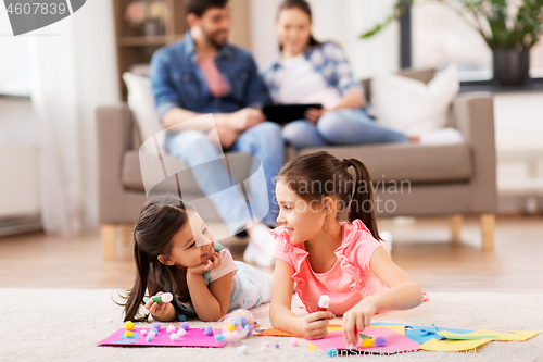 Image of happy sisters doing arts and crafts at home