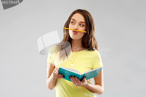 Image of teenage student girl with notebook and pencil