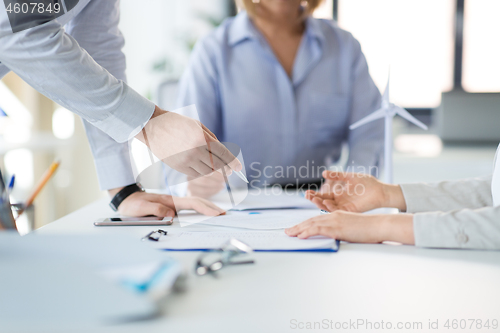 Image of business team discussing papers at office