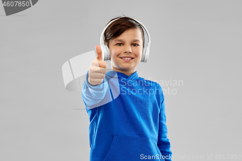 Image of portrait of smiling boy in blue hoodie