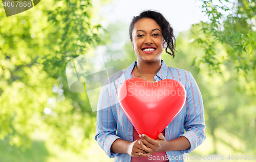 Image of african american woman with heart-shaped balloon