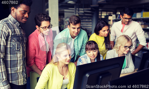 Image of international students with computers at library