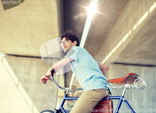 Image of young hipster man riding fixed gear bike