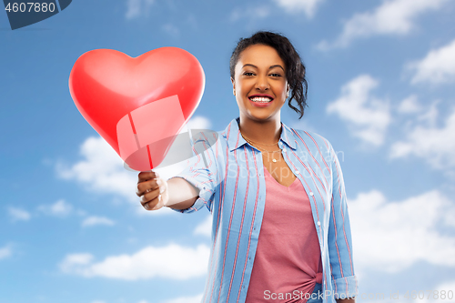 Image of african american woman with heart-shaped balloon