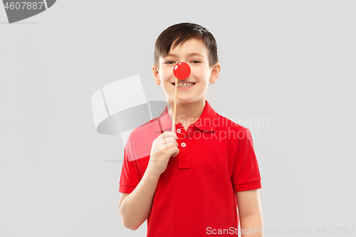 Image of smiling boy with red clown nose party prop