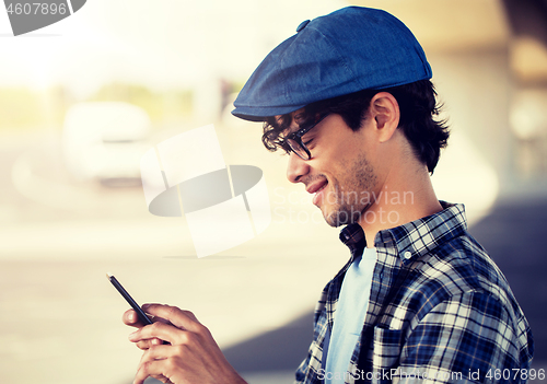 Image of hipster man texting message on smartphone
