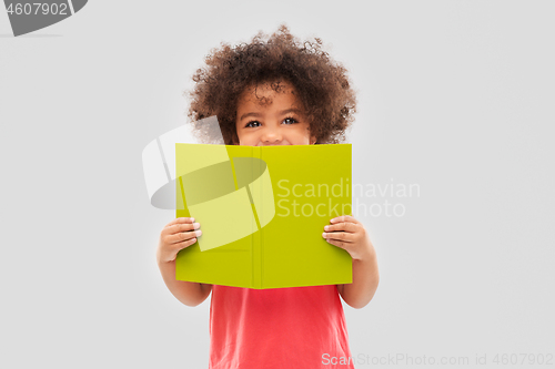 Image of happy little african american girl with book