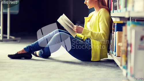 Image of high school student girl reading book at library