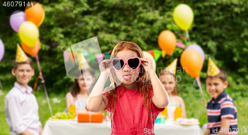 Image of naughty red haired girl in heart shaped sunglasses