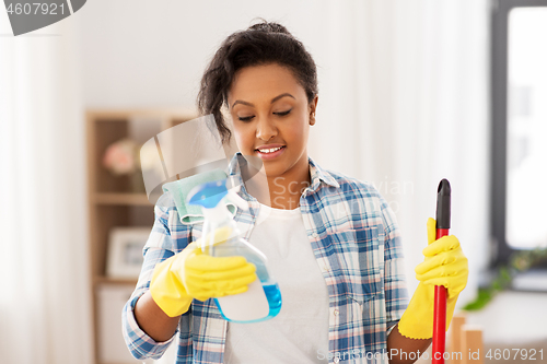 Image of african american woman with detergent at home