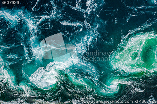 Image of Waves of water of the river and the sea meet each other during h