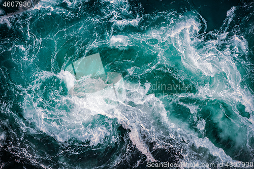 Image of Waves of water of the river and the sea meet each other during h