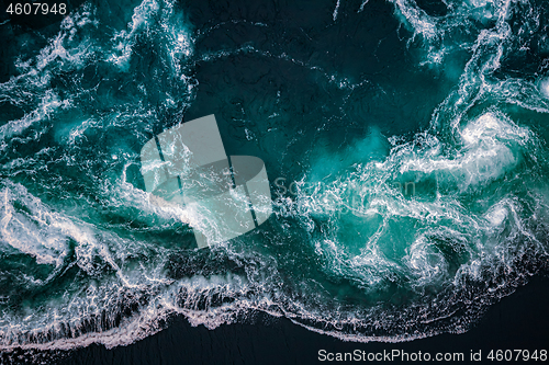 Image of Waves of water of the river and the sea meet each other during h