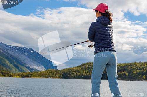 Image of Woman fishing on Fishing rod spinning in Norway.