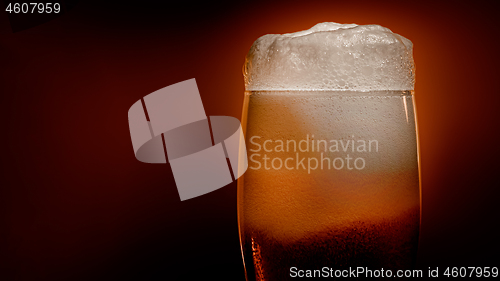 Image of Lager beer settles in the glass with a white cap of foam