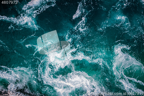 Image of Waves of water of the river and the sea meet each other during h