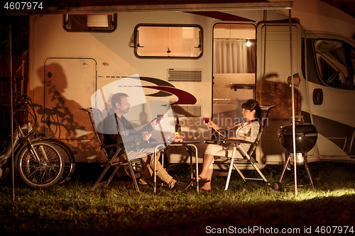 Image of Adult couple clinking glasses of wine. Family vacation travel RV