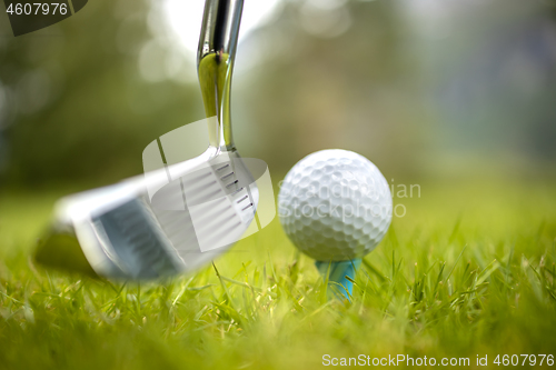 Image of Golf ball on tee in front of driver