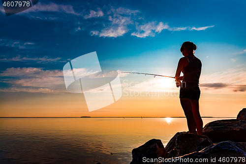 Image of Woman fishing on Fishing rod spinning in Norway.