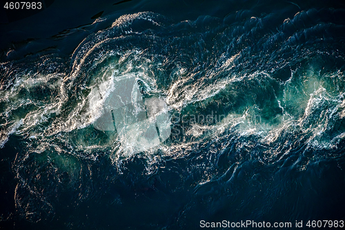 Image of Waves of water of the river and the sea meet each other during h