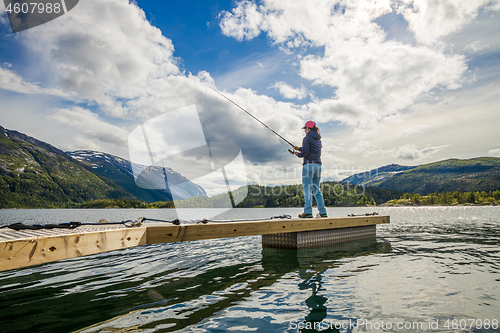 Image of Woman fishing on Fishing rod spinning in Norway.