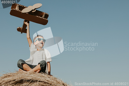 Image of Happy little boy playing  in the park at the day time. 