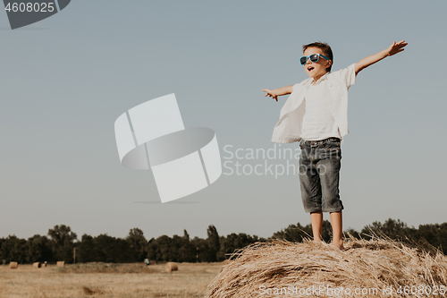 Image of Happy little boy playing  in the park at the day time.