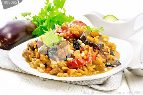 Image of Rice with vegetables and chicken in plate on light board