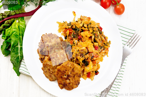 Image of Fritters meat with cabbage in plate on light board top