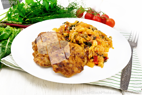 Image of Fritters meat with cabbage in plate on wooden board