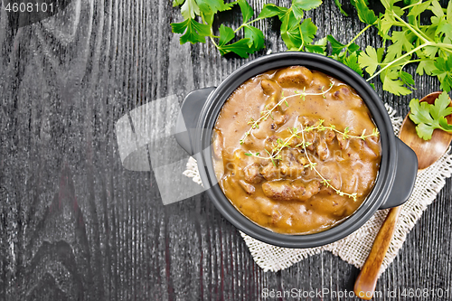 Image of Goulash of beef in pan on board top