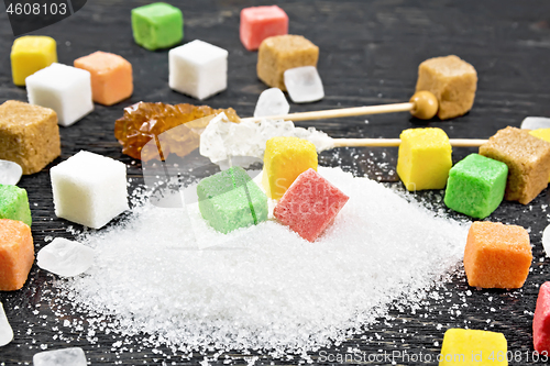 Image of Sugar of different colors and shapes on black board