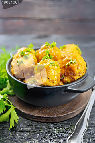 Image of Meatballs in brazier with greens on board