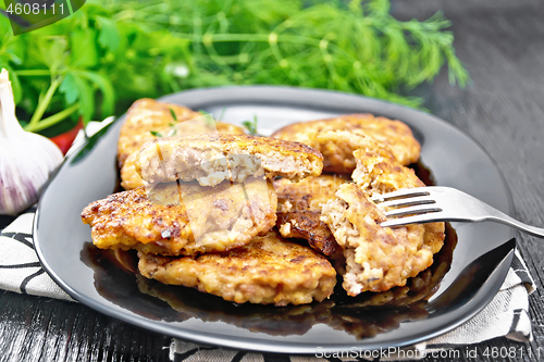 Image of Fritters meat in black plate on board