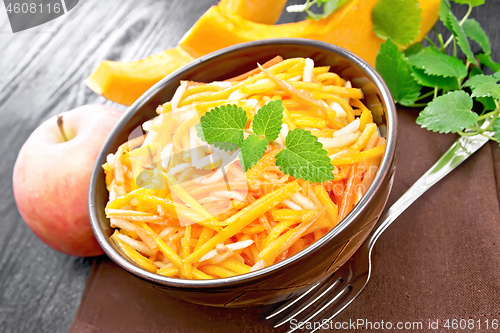 Image of Salad of pumpkin and apple in bowl on table