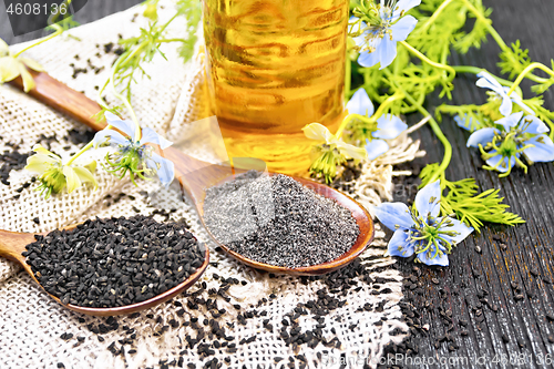 Image of Flour and seeds of kalingi in spoons on old board