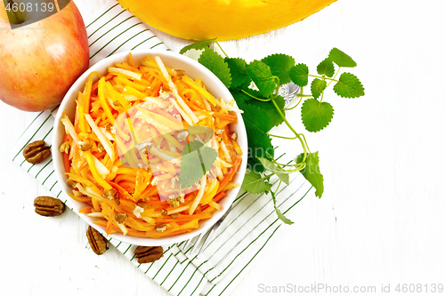 Image of Salad of pumpkin and apple in bowl on board top