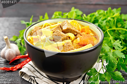 Image of Lagman in bowl on dark wooden board