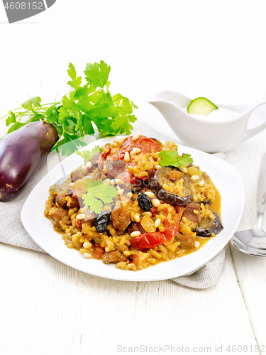 Image of Rice with vegetables and chicken in plate on white wooden board