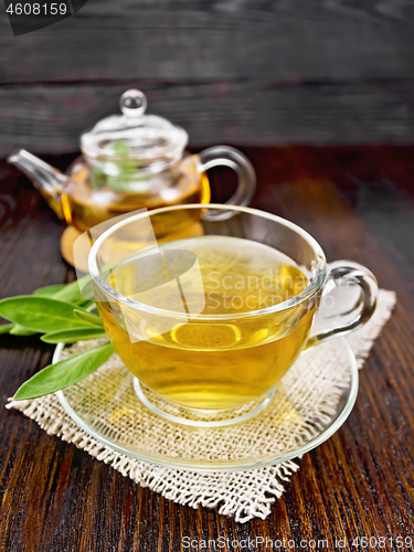 Image of Tea herbal with sage in glass cup on napkin