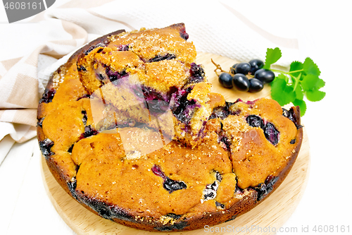 Image of Pie with black grapes on white board