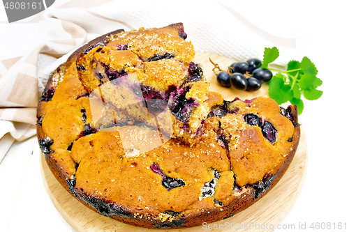 Image of Pie with black grapes on white board