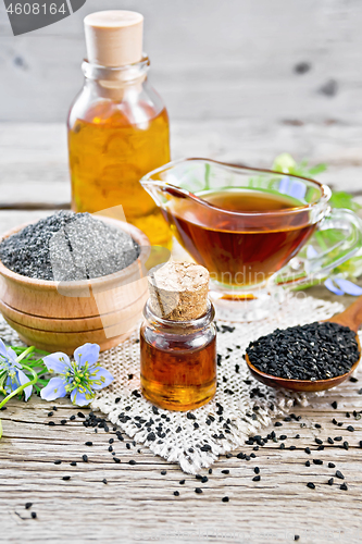 Image of Oil kalingi in bottles and gravy boat on gray board