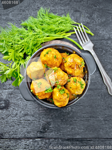 Image of Meatballs in black brazier on board top