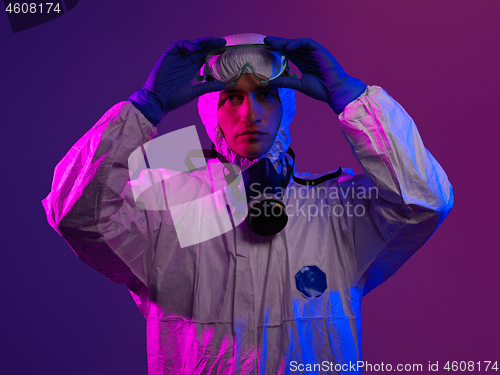 Image of Doctor wearing protective biological suit and mask due to corona