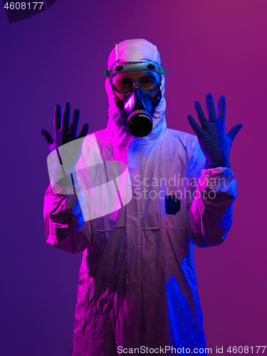 Image of Doctor wearing protective biological suit and mask due to corona