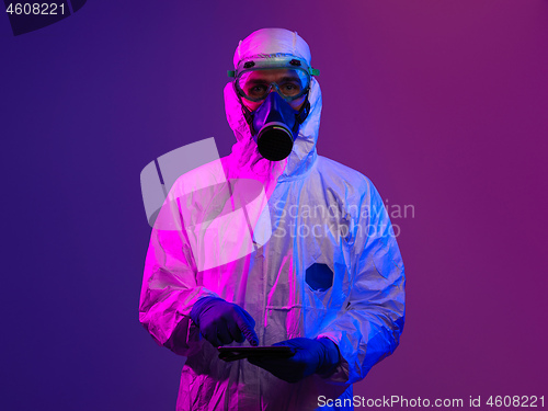Image of Doctor wearing protective biological suit and mask due to corona