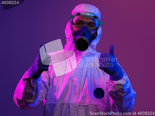 Image of Doctor wearing protective biological suit and mask due to corona