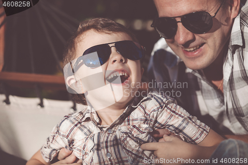 Image of Father and son playing in the park at the day time.